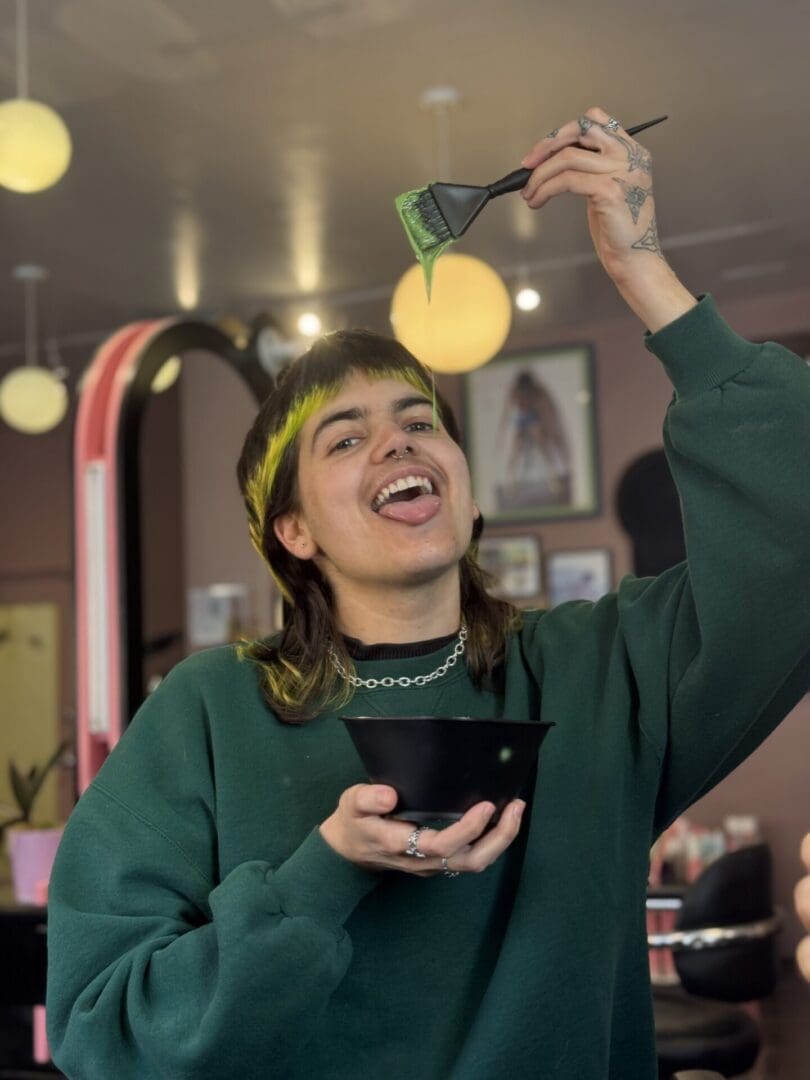 A woman holding a bowl and smiling at the camera.