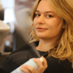 Woman at salon with blonde hair spray.