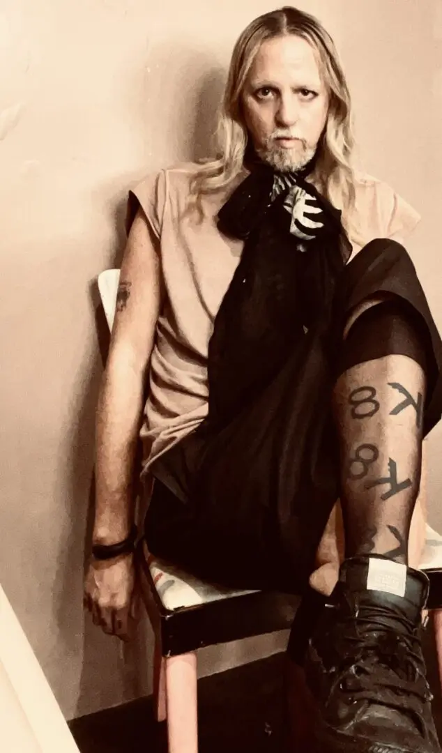 A woman sitting on the ground wearing tights.