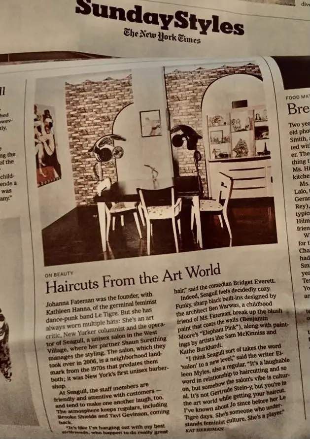 A newspaper article with an image of two people sitting at a table.