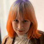 Person with colorful orange and purple hair.
